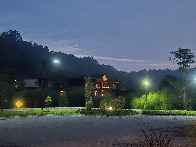 The estate road at dusk with hills behind