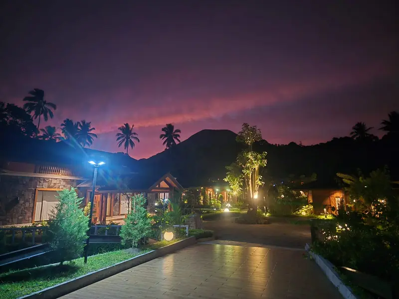The path between villas under a pink sunset