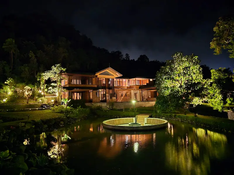 The Grand Villa and fountain pond at night
