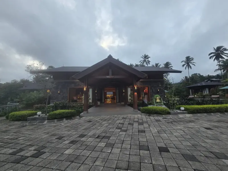 The main lodge and paved courtyard under a cloudy sky
