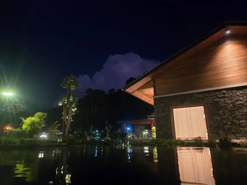 Villa lights reflected in the pool at night