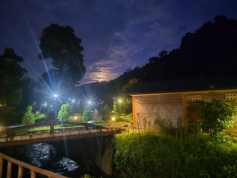 A footbridge over the stream at night